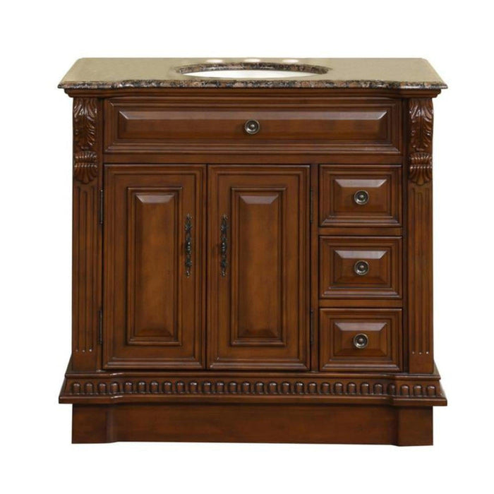 Rich wood bathroom vanity with marble top, ornate carved details, two cabinet doors, and three drawers on right side