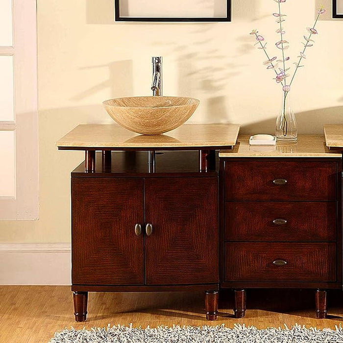 Dark wood bathroom vanity with stone vessel sink, chrome faucet, and delicate floral branch in glass vase.
