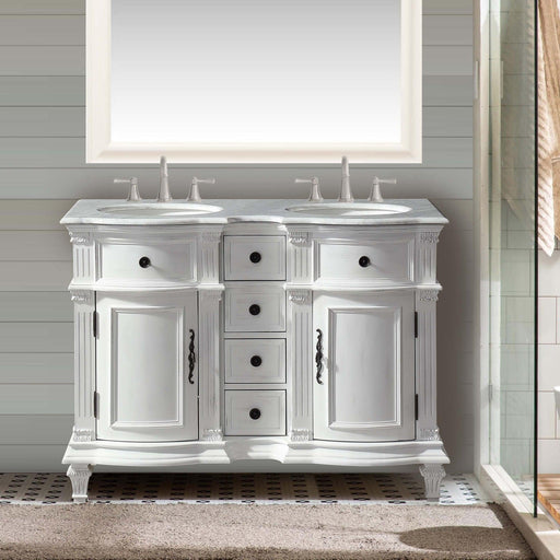 Elegant white double-sink bathroom vanity with ornate details, marble countertop, and black hardware, placed on patterned tile flooring.