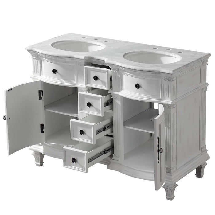 White double-sink bathroom vanity with ornate details, multiple drawers open to reveal storage space, marble top with oval sinks.