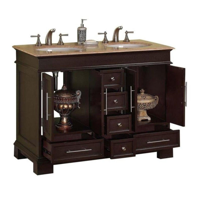 Dark wood bathroom vanity with double sinks, marble top, and decorative drawers open to reveal ornate ceramic lamps.
