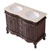 Ornate dark wood bathroom vanity with curved cabinets, decorative carved details, and a cream-colored stone top with two oval sinks.