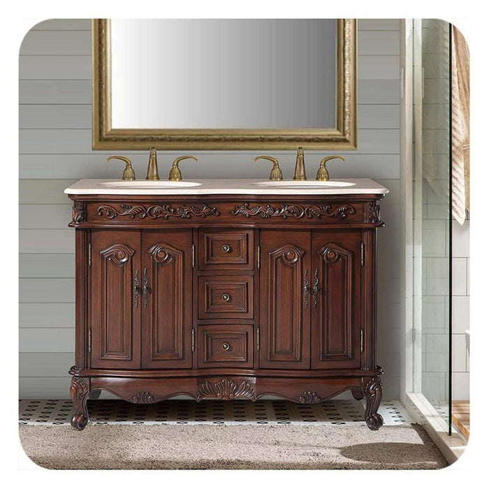 Ornate wooden bathroom vanity with double sinks, marble top, gold fixtures, and carved baroque-style details on dark wood cabinet.