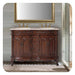 Ornate wooden bathroom vanity with double sinks, marble top, gold fixtures, and carved baroque-style details on dark wood cabinet.
