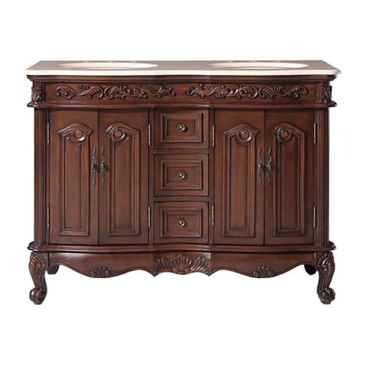 Ornate wooden bathroom vanity with curved legs, carved details, marble top, and two sinks