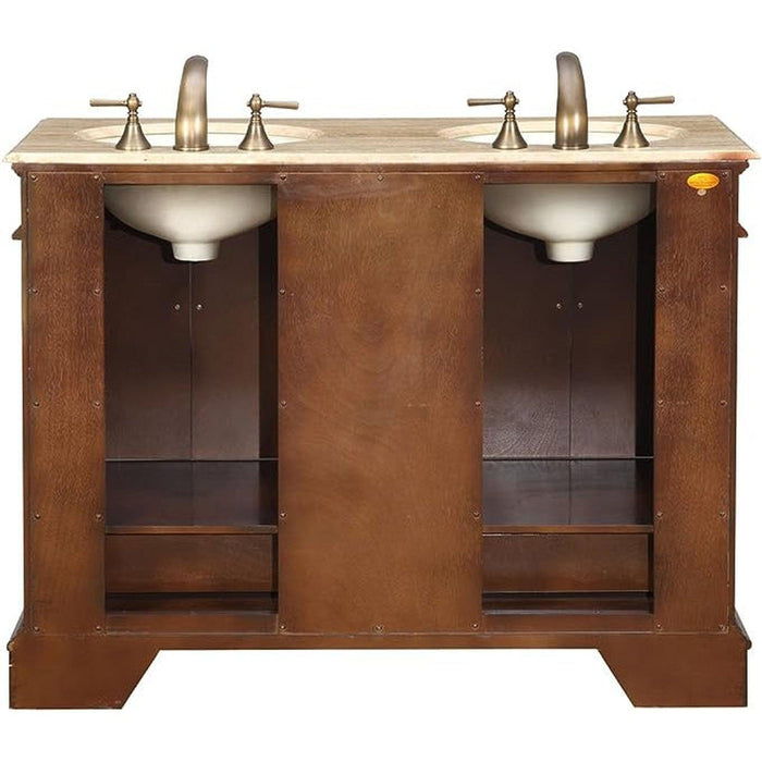 Double sink vanity with wood cabinet, stone countertop, and antique brass faucets and fixtures.