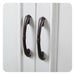 Two dark bronze curved cabinet handles on white paneled doors, with decorative twisted mid-section detailing.