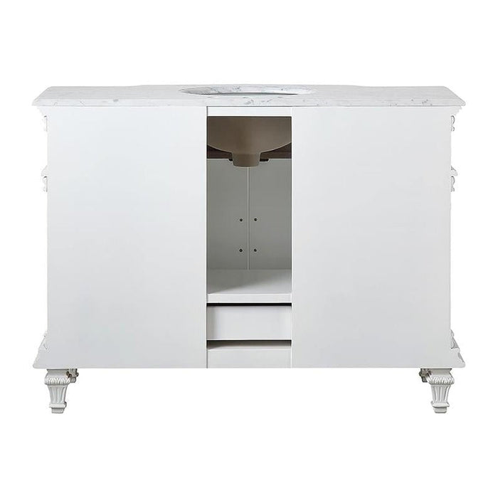 White marble-topped bathroom vanity with ornate legs and central sink basin, two cabinet doors, and decorative side details.