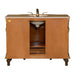 Wooden bathroom vanity with bronze faucet and marble countertop, featuring carved legs and central cabinet storage.