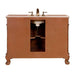 Vintage-style bathroom vanity in warm brown with curved legs and white marble countertop, featuring a centered sink and ornate faucet handles.