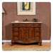 Elegant wooden bathroom vanity with ornate carved details, six drawers, marble top, and decorative sink with vintage-style fixtures.