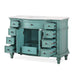 Vintage teal wood desk with multiple open drawers and ornate carved details, white marble top, decorative hardware.