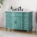 Vintage-style turquoise bathroom vanity with ornate details, white marble top, black faucet, and six drawers.