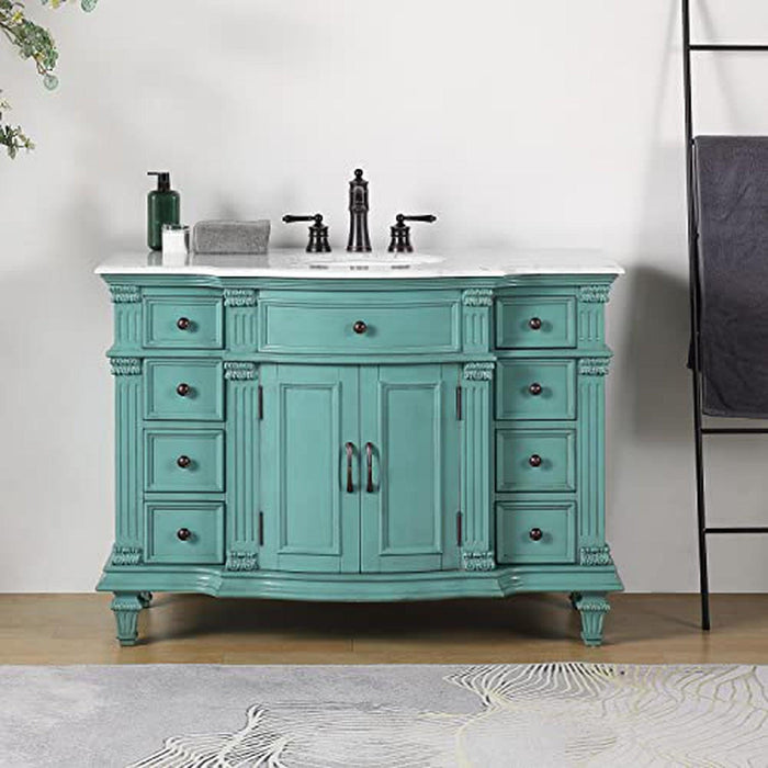 Vintage-style turquoise bathroom vanity with white marble top, six drawers, and black fixtures.