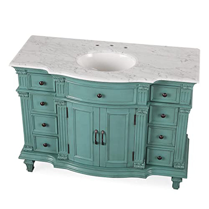 Vintage teal bathroom vanity with marble top, six drawers, and central cabinet doors with ornate carved details.