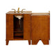 Wood bathroom vanity with marble top, gold faucet, and open cabinet doors revealing interior storage shelf.