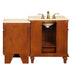 Wooden bathroom vanity with white marble top, brass faucets, and open cabinet storage on decorative legs.