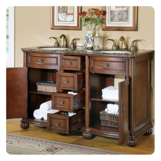 Elegant wooden bathroom vanity with marble top, multiple drawers, brass faucets, and white towels neatly stacked on shelves.