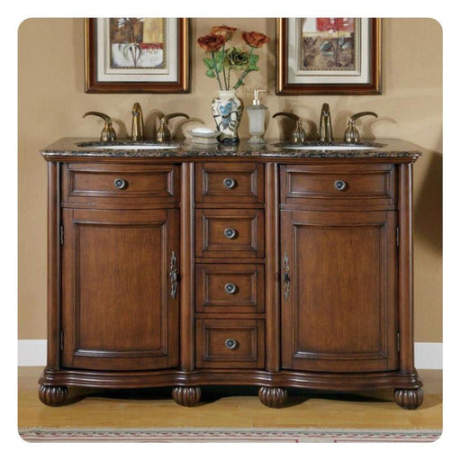 Elegant wooden bathroom vanity with marble top, double sinks, decorative drawers, and framed floral artwork in background.