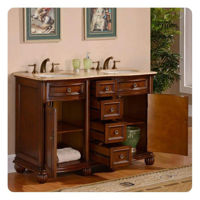 Rich wood bathroom vanity with marble top, double sinks, and decorative green accents, featuring multiple drawers and an open storage shelf.