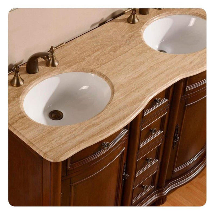Rich wood bathroom vanity with curved design, two white oval sinks, and bronze faucet fixtures.