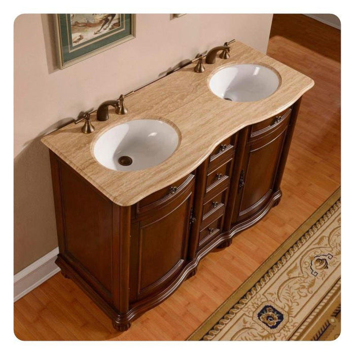 Elegant wooden double-sink vanity with curved edges, travertine countertop, and antique bronze fixtures on hardwood floor.