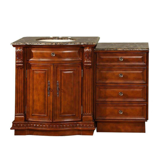 Rich cherry wood bathroom vanity with marble top, featuring ornate cabinet doors and four side drawers with decorative hardware.