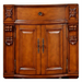Ornate wooden cabinet with decorative carved details, curved edges, and two-door storage with elegant metal handles.