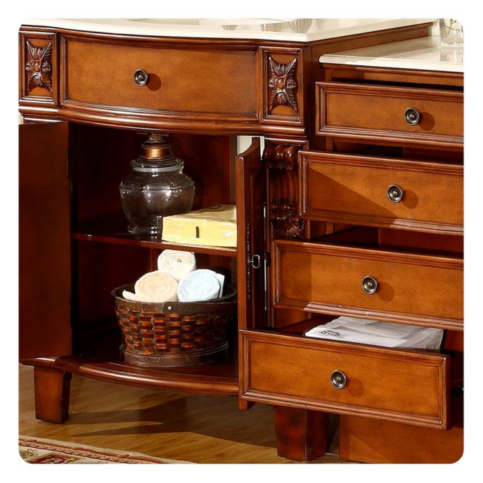Elegant wooden dresser with ornate carved details, multiple drawers, and open shelving holding a woven basket of towels and an antique lamp.