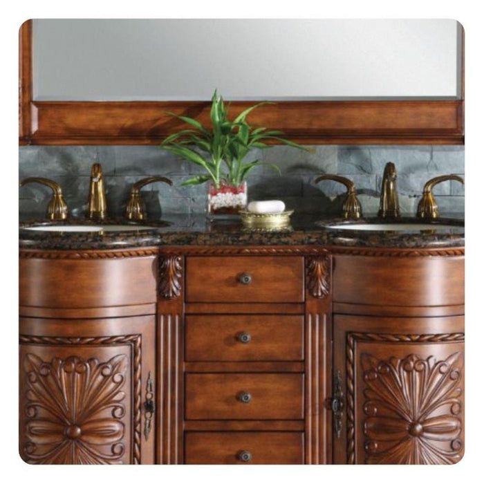 Ornate wooden bathroom vanity with marble countertop, brass faucets, and green plant in center, featuring carved floral details on cabinet doors.