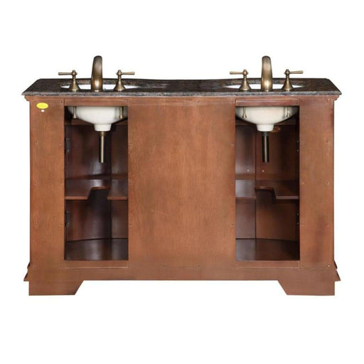 Double vanity with wood cabinet, marble top, bronze faucets and white sinks, storage shelves visible on sides.