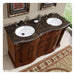 Rich wood bathroom vanity with Baltic brown granite top, double white sinks and ornate bronze faucets.