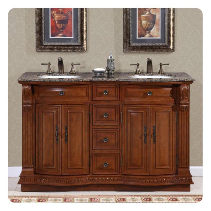 Elegant wooden bathroom vanity with granite countertop, two sinks, ornate framed urn artwork, and decorative bathroom accessories.