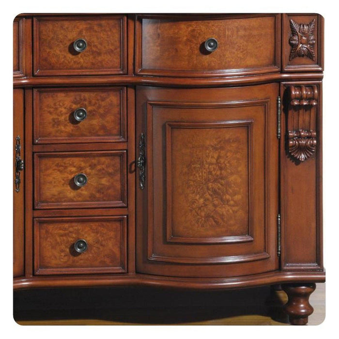 Ornate wooden furniture piece with curved drawers, rich burl wood grain, decorative carved details, and round black drawer pulls.