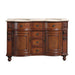 Ornate wooden bathroom vanity with curved drawers, marble top, and two oval sinks in rich brown finish.