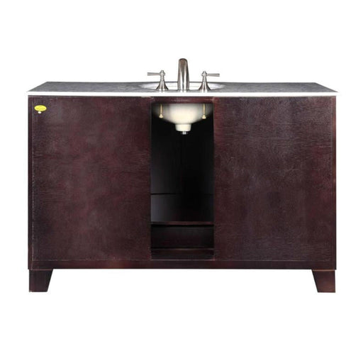 Dark wood bathroom vanity with white marble top and central undermount sink with silver faucet handles.