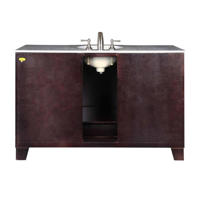 Dark wood bathroom vanity with white marble top and central undermount sink with silver faucet handles.