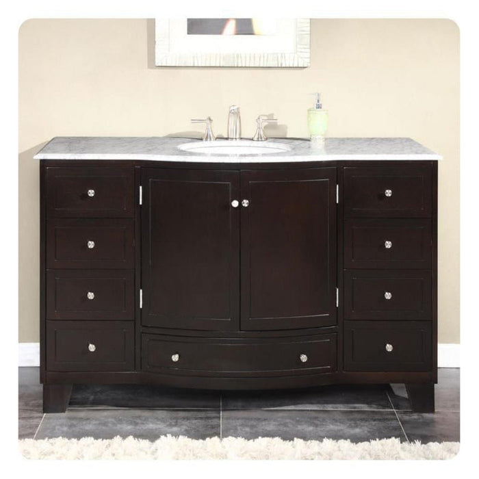 Dark wood bathroom vanity with marble countertop, centered sink, chrome faucet, and six drawers with round silver knobs.