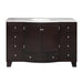 Dark wood bathroom vanity with marble top, oval sink, and six drawers with crystal knobs.