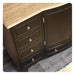 Dark wood dresser with travertine top, four drawers, and decorative silver knobs, curved front design.