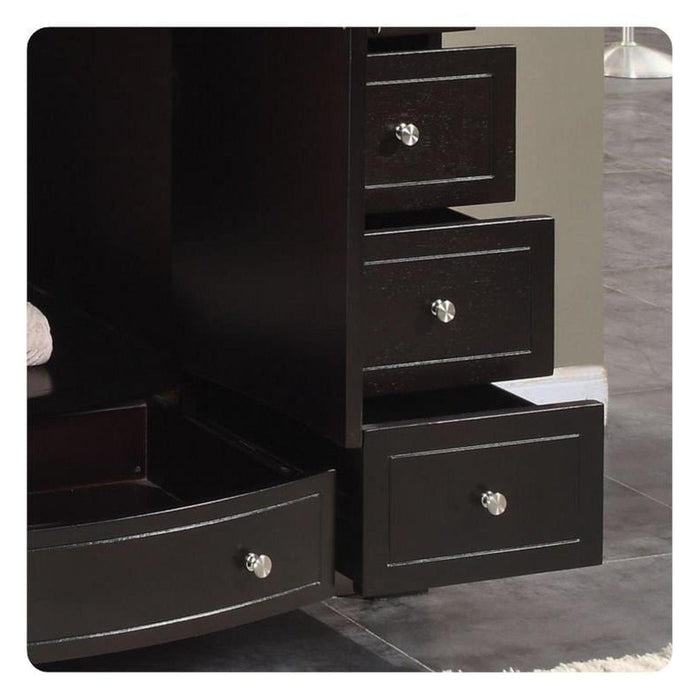 Black wooden dresser with multiple drawers and silver round drawer pulls on a tiled floor