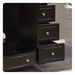 Black wooden dresser with multiple drawers and silver round drawer pulls on a tiled floor