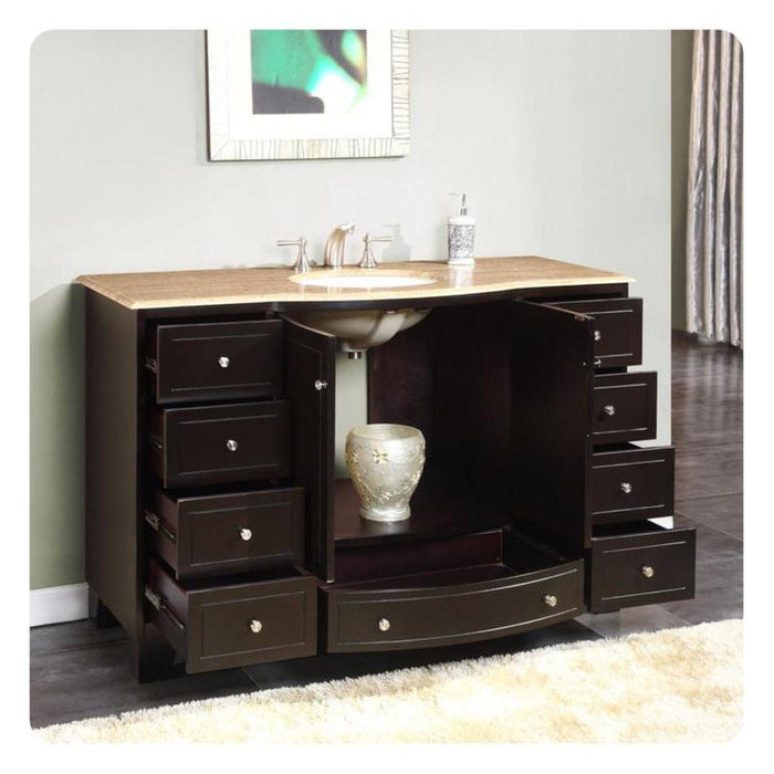 Dark wood bathroom vanity with multiple drawers, travertine countertop, and built-in sink with decorative ceramic vase
