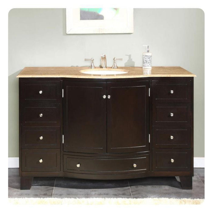 Dark wood bathroom vanity with travertine top, six drawers, center cabinet, and undermount sink with chrome faucet fixtures.