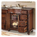 Rich wood bathroom vanity with granite top, decorative drawers open, displaying ornate basket and lemons.