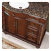 Ornate wooden bathroom vanity with Baltic brown granite top, carved details, and decorative brass hardware