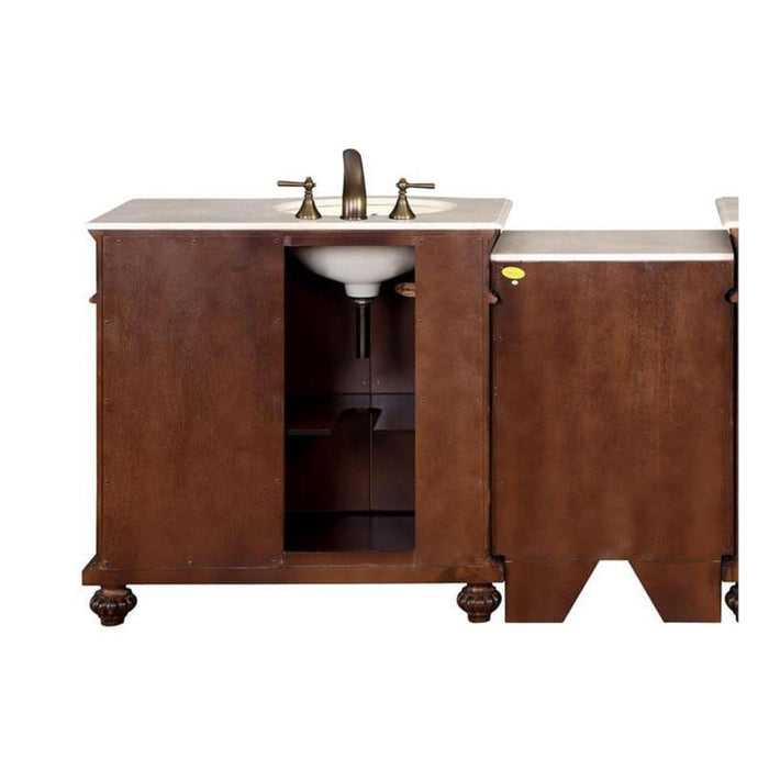 Dark wood bathroom vanity with white marble top, undermount sink, and ornate brass faucet fixtures.