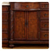 Rich mahogany cabinet with ornate carved details, double doors, decorative hardware, and elegant rope-twist trim.