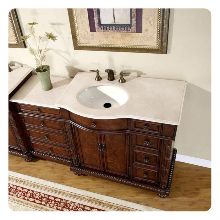 Elegant wooden bathroom vanity with white marble countertop, ornate carved details, and antique bronze faucet fixtures.