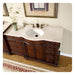 Elegant wooden bathroom vanity with white marble countertop, ornate carved details, and antique bronze faucet fixtures.